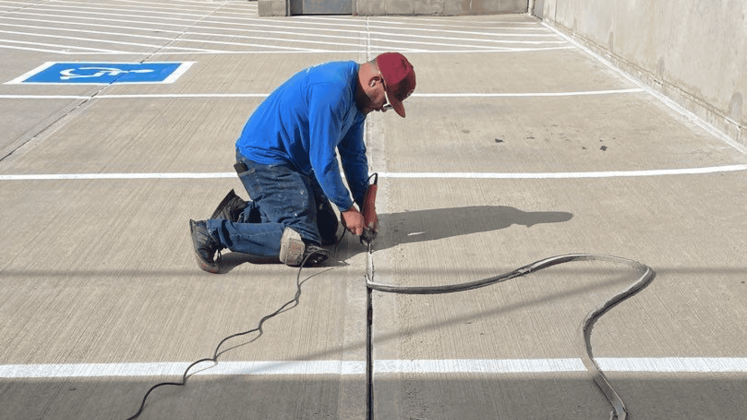 person repairing concrete parking space