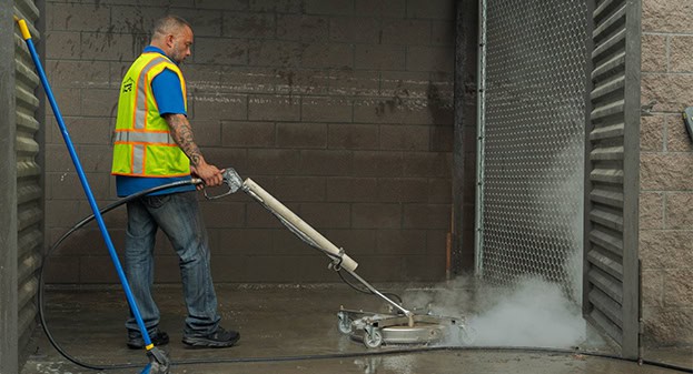 DCPS worker using power washing equipment