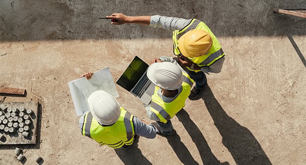Men in construction directing work